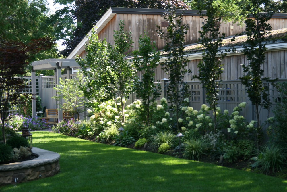 fence, arbor, columnar beeches, teak bench, fountain