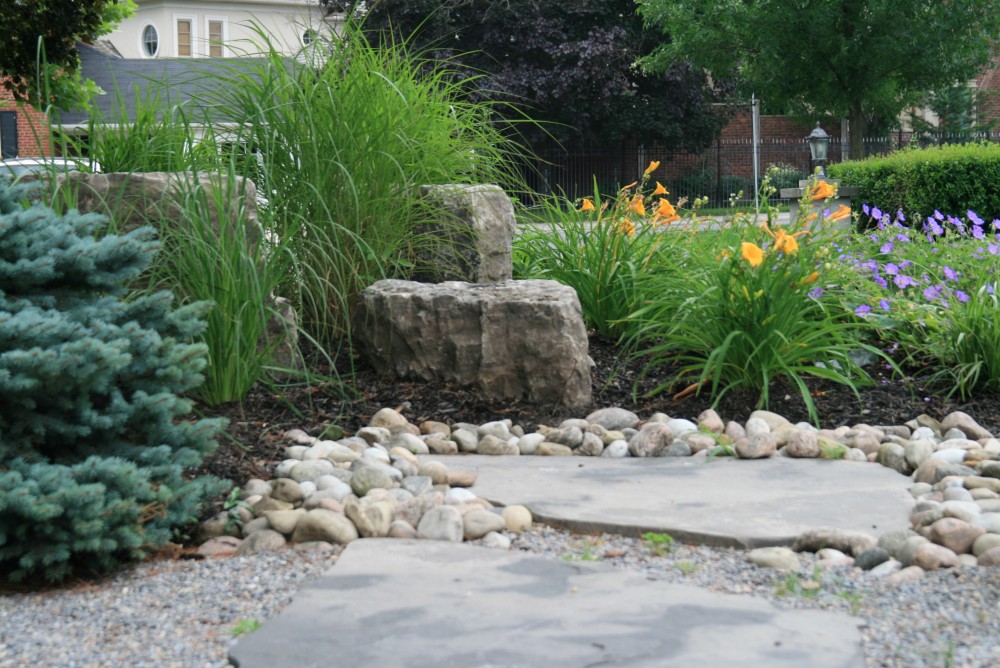 circular driveway, rockery, armor stone, grasses, natural stone slab